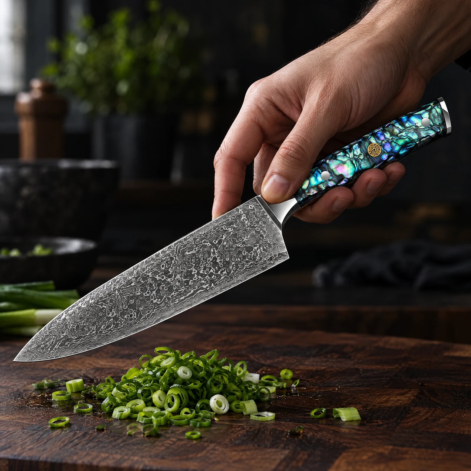 Natural abalone shell handle with polished steel fittings and a gold mosaic rivet