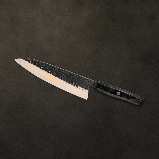 The Obsidian chef knife on dark basalt stone